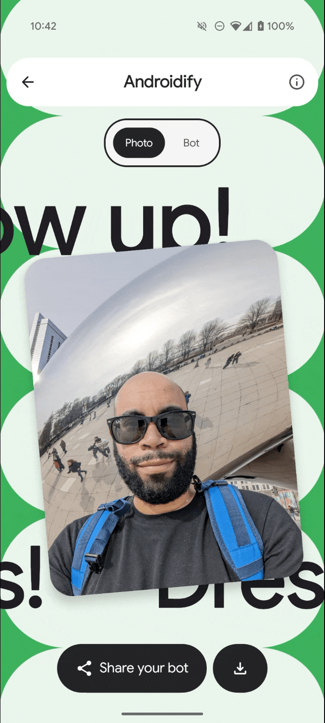moving image of Androidify app demo turning a selfie image of a bearded man wearing a black tshirt and sunglasses, with a blue back pack into a green 3D bearded droid wearing a black tshirt and sunglasses with a blue backpack
